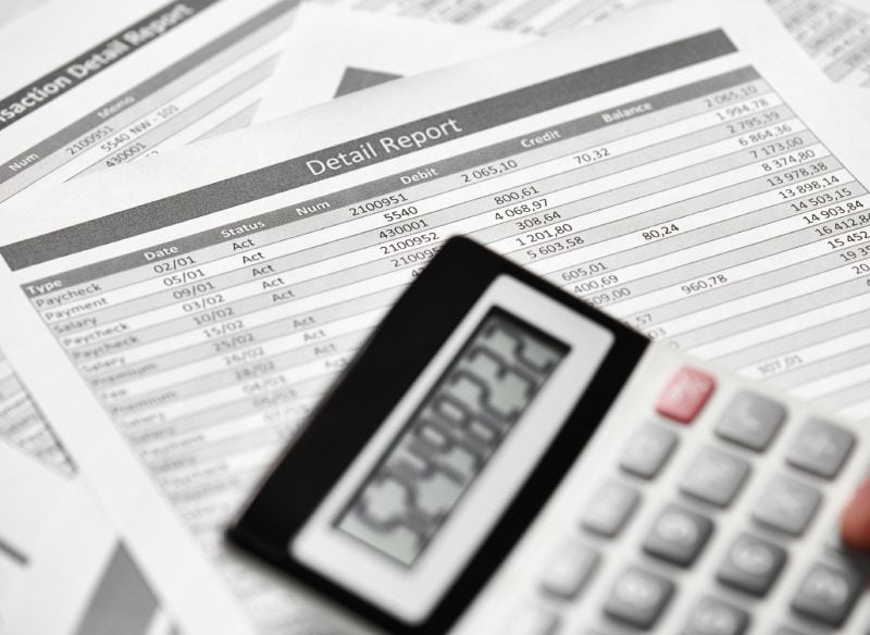 Compilation Services A close up of an accountant using a calculator.
