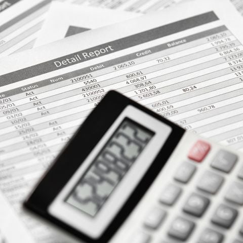 A close up of an accountant using a calculator.